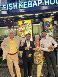 a group of people posing for a picture in front of a restaurant at SkyLife OldCity Hotel in Istanbul
