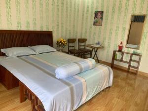 a bedroom with a bed and a table and chairs at Thủ Đức home in Ho Chi Minh City
