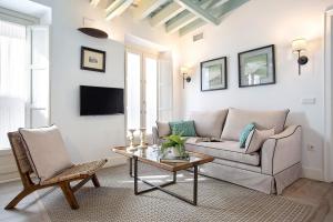 a living room with a couch and a table at Genteel Home Padre Marchena in Seville