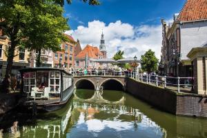 a bridge over a river in a city at Pat's home in Alkmaar