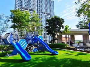 a playground in a park with a blue slide at Near Georgetown with Beautiful city view 2 room fit 4 to 7 pax in Jelutong