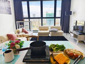 a living room with a table with food on it at Near Georgetown with Beautiful city view 2 room fit 4 to 7 pax in Jelutong