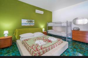 a bedroom with a bed and a bunk bed at B&S Beach villa con piscina in Fontane Bianche