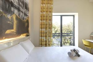 Кровать или кровати в номере B&B Hotel Savona
