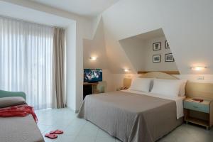 a hotel room with a bed and a television at Hotel Romagna in Cattolica
