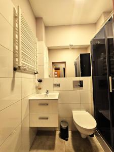 a white bathroom with a toilet and a sink at Dark Romance- Apartament BDSM Greya dla Zakochanych Par in Ruda Śląska