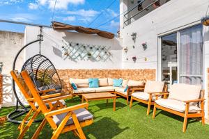 a patio with chairs and a swing at Tío Salvador in Bolbaite