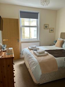 a bedroom with two beds and a window at Rosalie Guest House in Penzance