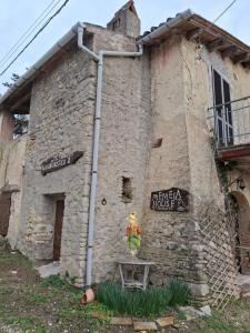 a stone building with a sign on the side of it at Memela House in Poggio Mirteto