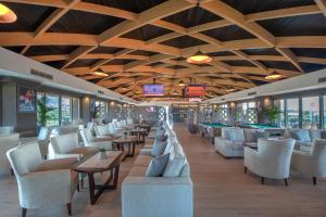 a restaurant with tables and chairs and pool tables at Lyttos Beach in Hersonissos +83 photos