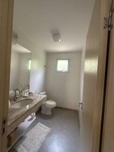 un bagno con lavandino, WC e specchio di Casa Villa Firenze a Mata de Sao Joao