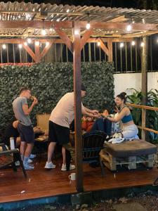 a group of people eating food in a room at Carolina Hostel in San José