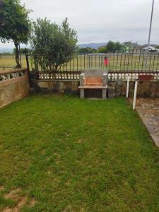 a park with a bench in the grass at A Pedriña Ribadeo in Ribadeo