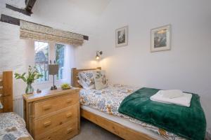 Ένα ή περισσότερα κρεβάτια σε δωμάτιο στο Rose Cottage