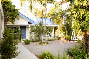 a courtyard with trees and a house at Zea Za Bungalow in Hua Hin