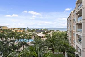 an aerial view of a resort with a pool and palm trees at Beach View - Beach Royale 2BR condo - LV406 in Palm-Eagle Beach