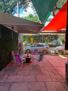 a patio with chairs and a table under a canopy at Reserva 69 Hostel in Sao Paulo