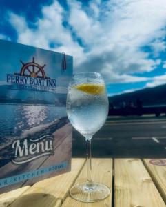 a wine glass sitting on a table next to a box at The Ferry Boat Inn in Ullapool +46 photos