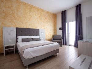 Un pat sau paturi într-o cameră la Corte dei Limoni - Affittacamere - Living Sant'Antioco