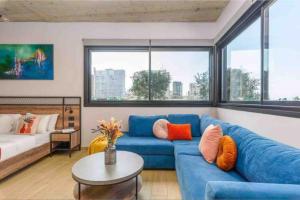 a living room with a blue couch and a table at Amine Apart-Hotel by Stayinn in Beirut