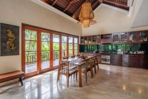 a large kitchen with a dining table and chairs at Boutique hotel villa Cantik and karma beach club in Uluwatu