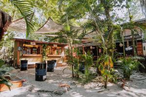 a restaurant with palm trees in front of a building at Bossa Beach House in Ilha do Mel