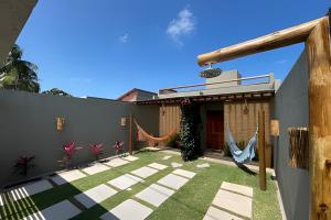a garden outside a house with hammocks at Manga Verde Milagres in São Miguel dos Milagres