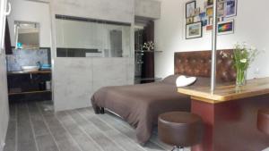 a bedroom with a bed and a table with a chair at La Chambrette in Salon-de-Provence