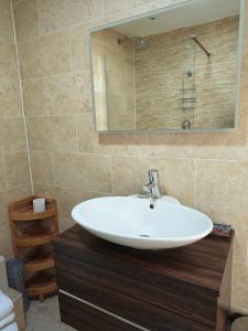 a bathroom with a sink and a mirror at Penthouse in Luxor House in London