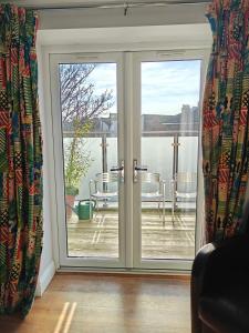 a sliding glass door with a view of a patio at Penthouse in Luxor House in London