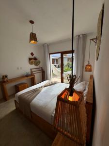 a bedroom with a large bed and a window at Villa Maria - Serra Grande in Uruçuca