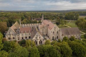 an aerial view of a large building with trees at Abbaye de Royaumont in Viarmes