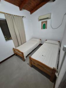 Una pequeña habitación con dos camas y una ventana. en Chacra mita í, en La Cruz 72 fotos más