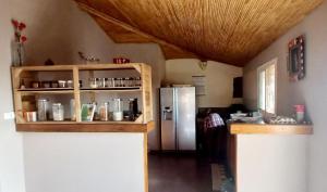 eine Küche mit einem Kühlschrank aus Edelstahl und einem Regal in der Unterkunft Kalahari Estate, Prestige & Quiet in Sali Poulang