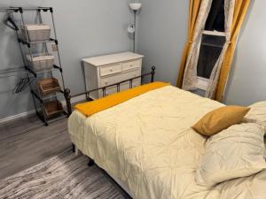 a bedroom with a bed with a yellow blanket on it at Pennsboro WV 'Country Roads' in Pennsboro