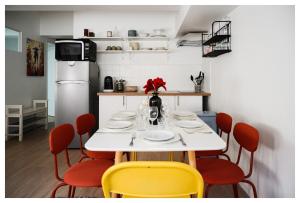 a dining room with a white table and yellow chairs at Beau 3P à 20m du métro et 20 min du cœur de Paris in Les Lilas +19 photos