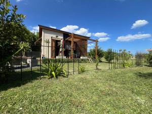 a fence in front of a small house at Los colibries in Mar de Cobo