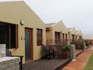 a row of houses on a deck at Walvis Bay Backpackers & Self-catering in Walvis Bay