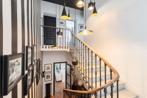 a hallway with a spiral staircase with pendant lights at Lidia by Terrys Homes in Le Cannet +11 photos