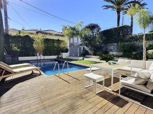 a patio with a table and chairs and a pool at Lidia by Terrys Homes in Le Cannet