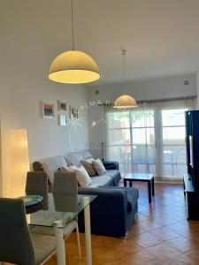 a living room with a couch and a table at Calma House in Caleta De Fuste
