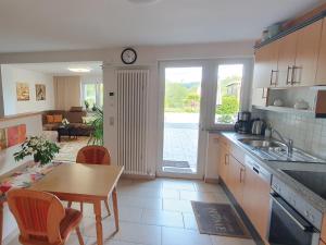 a kitchen with a table and a dining room at Elisa Ferienwohnung in Wadern