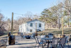 a table and chairs in front of a white house at Time to Wine Down - Family Home in Afton
