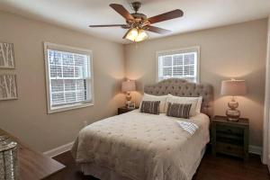 a bedroom with a bed with a ceiling fan at Time to Wine Down - Family Home in Afton +56 photos