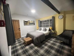 a bedroom with a bed and a chair in it at Hilston Park in Monmouth