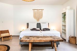 a bedroom with a bed and a table with a laptop on it at Villa Leon Spacious Tropical Villa with pool and outdoor kitchen in Jan Thiel +41 photos