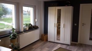 a hallway with a white door and a window at Ferienhaus Montessori in Naundorf