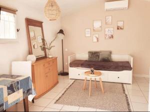 a bedroom with a bed and a table in it at le Studio charme et tranquillité in Plan-de-la-Tour