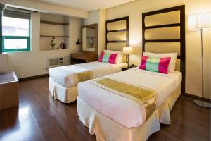 A bed or beds in a room at Vieve Hotel