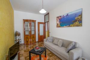 a living room with a couch and a table at Casa Ersilia in Agerola
